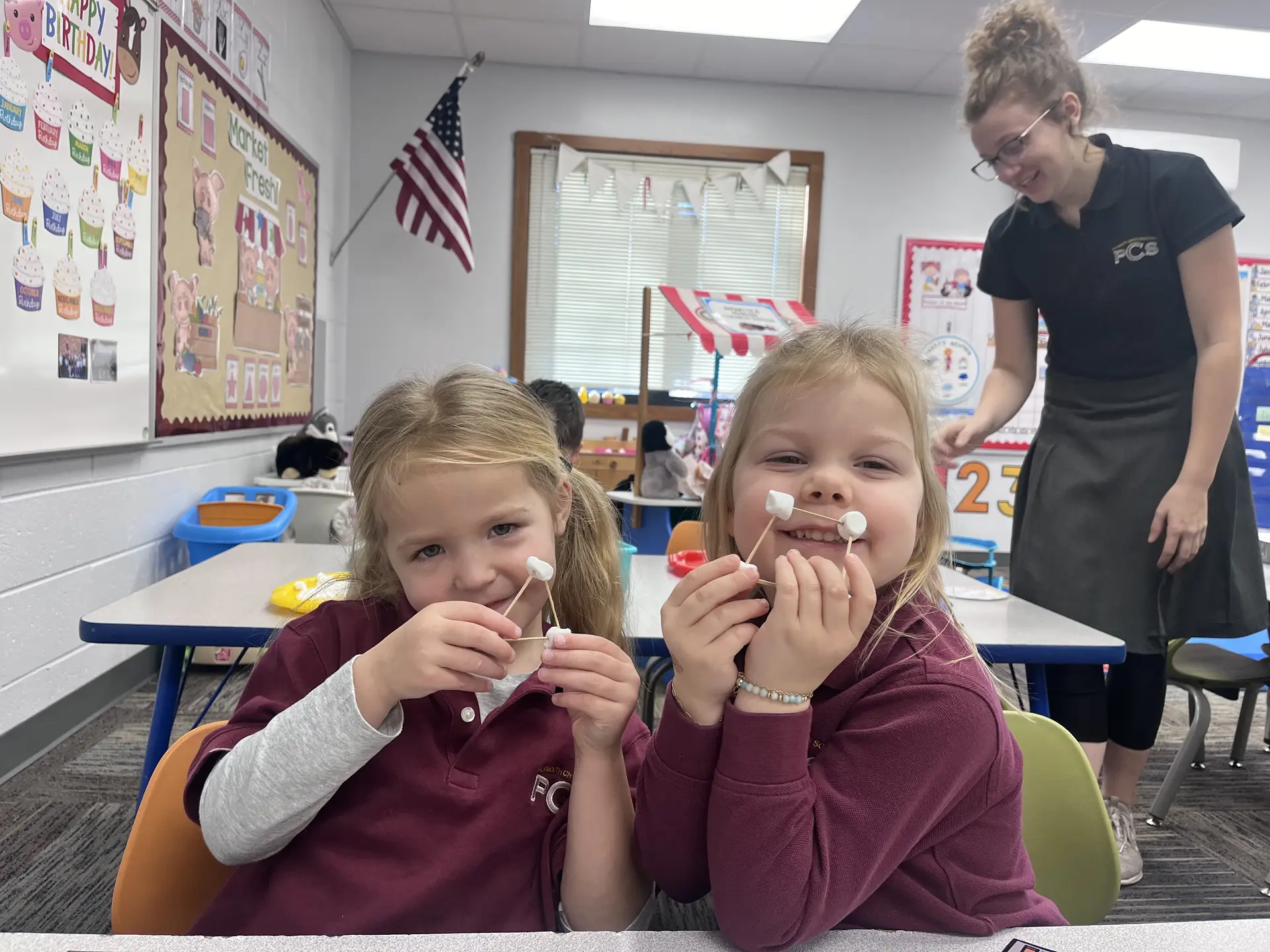 Two young students laughing together in class