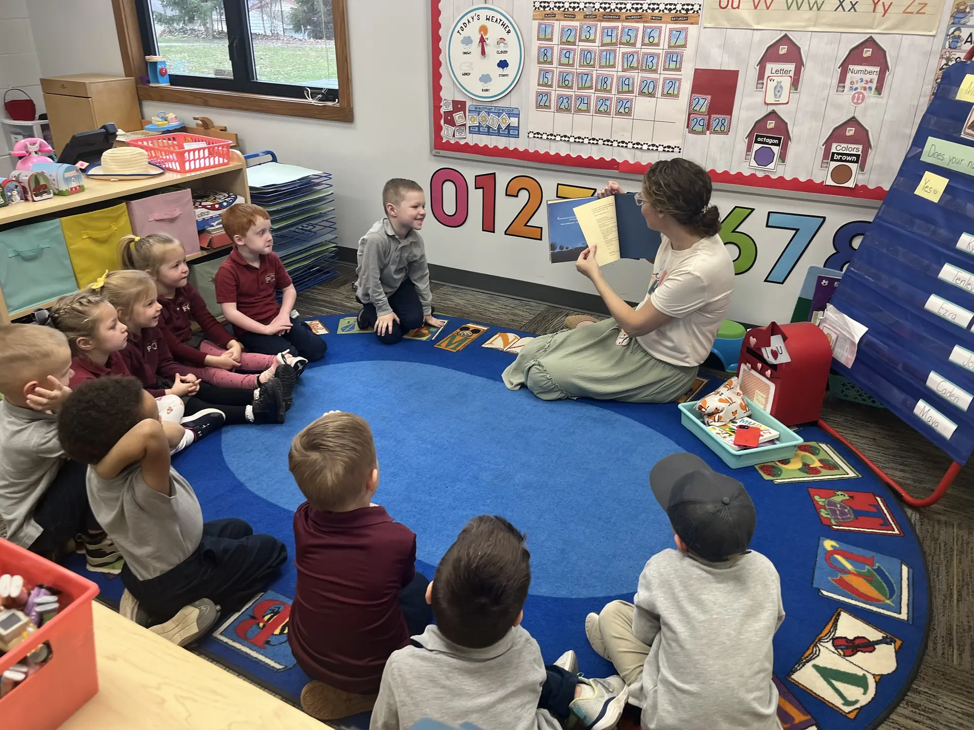 Kindergartners gathered on the classroom rug for circle time